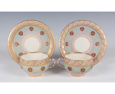 A pair of Royal Worcester reticulated cups and saucers, circa 1876, of double-walled construction, pierced with a honeycomb d