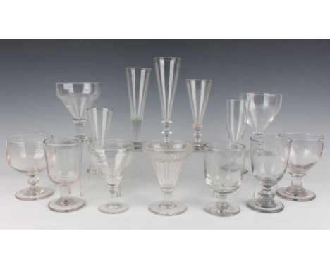 A small group of drinking glasses and rummers, mostly 19th century, including an engraved pan-topped example with rib-moulded