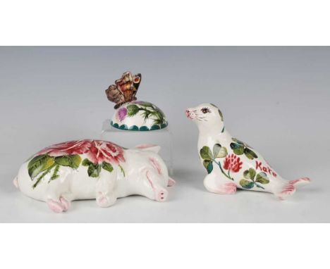 An Exon pottery Wemyss Ware sleeping piglet by Brian Adams, 1990s, painted with pink cabbage roses, green painted marks to ba