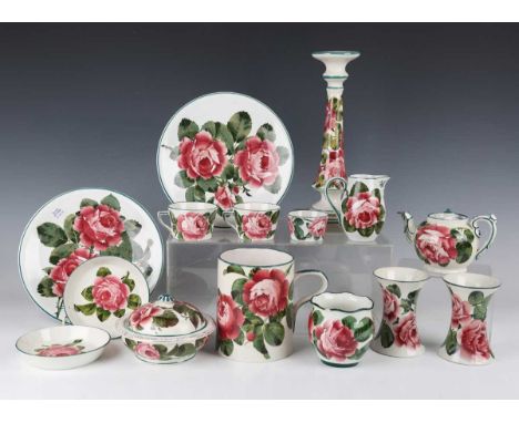 A group of Wemyss pottery painted with pink cabbage roses, circa 1900 and early 20th century, comprising tall candlestick, he