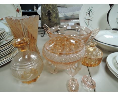 A selection of art deco pink pressed glass items including vase and fruit bowl