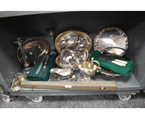 A variety of flat wear including sauce boats, cutlery, serving dishes, candle stick holders and more.