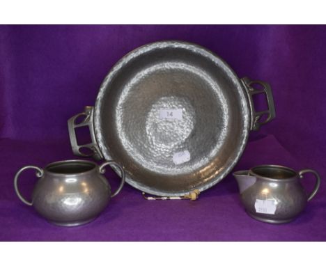 A Tudric pewter tazza or footed bowl having Art Nouveau styling and a Talbot pewter sugar basin and jug.