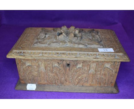A vintage carved oak box having extensive detail throughout.