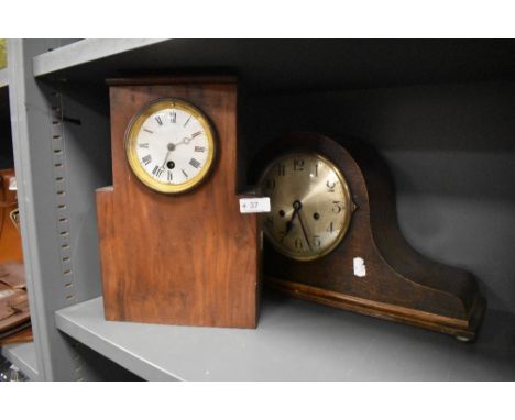 A vintage hump backed mantel clock and similar clock with Roman numerals to enamel face.
