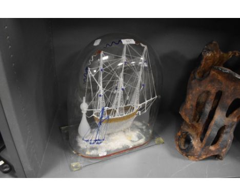 A fine example of a Victorian hand blown glass sailing ship boat or frigate and a smaller sail boat under glass dome in opal,