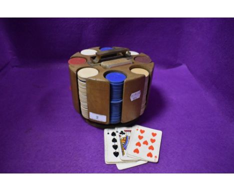 A Vintage rotating wooden poker chip caddy with cards and early plastic chips included.