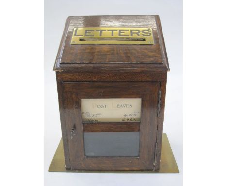 Edwardian brass-mounted manor house letterbox, the sloping front with pierced brass letter aperture, lockable glazed door to 