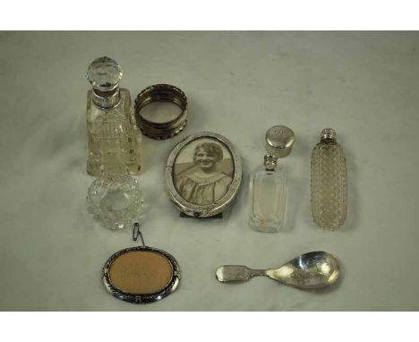 A small collection of hallmarked silver mounted Scent Bottles, Picture Brooch, Desk Frame, Napkin Ring, Plated Caddy Spoon et