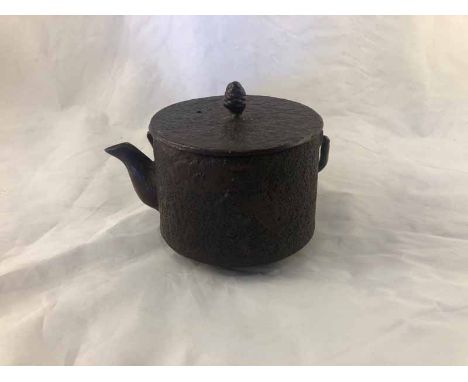 A Japanese Meiji period cast iron sake pot/teapot &amp; cover decorated with pine trees, the lid with pinecone knop.