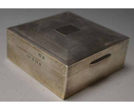 A silver square cigarette box, hinged cover, engine turned, vacant central rectangular cartouche, Birmingham 1970, 8.5cm wide