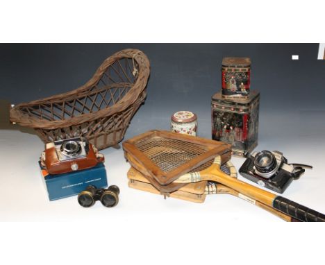 Boxes and Objects - a wicker doll's cradle; a deed box with key; a leather satchel; tennis racquets; a Minolta 35mm camera; a