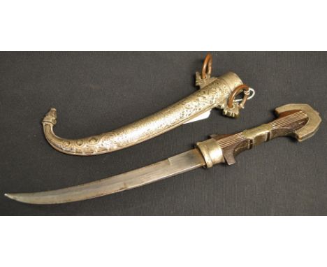 An Arabic silver mounted kindjal dagger, 23.5cm curved blade, fluted hardwood grip, the scabbard and mounts chased in the Isl