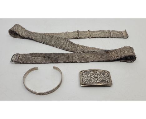 A white metal mesh belt fitted with rectangular curved buckle, (white metal assessed as silver), together with a&nbsp;silver 