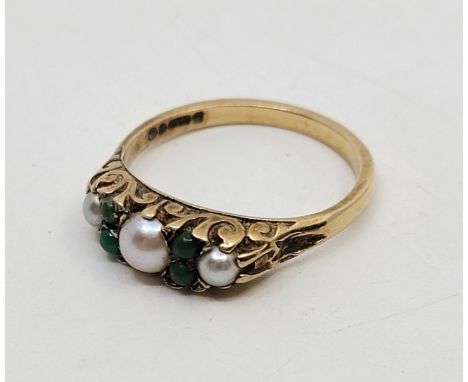 A 9ct. gold, pearl and green paste ring, set three graduated pearls alternating with two pairs of round cabochon paste, size 