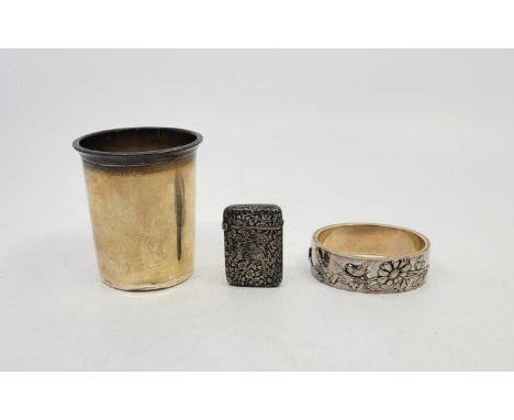 A Japanese unmarked silver and parcel gilt hinged bangle, one half decorated with a bee and bird amongst flowers and vines, m