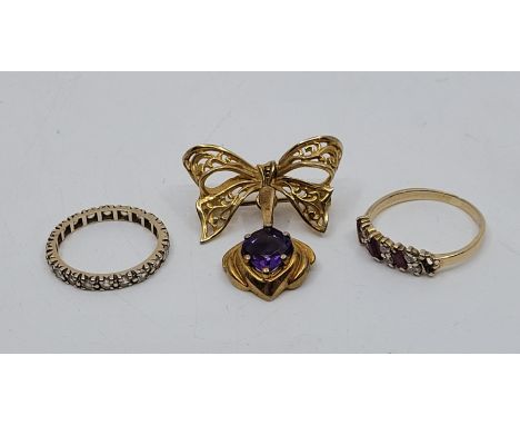 A 9ct. gold and amethyst brooch, having pierced tied gold bow suspending amethyst drop, width 26mm (gross weight 4.5g), a 9ct