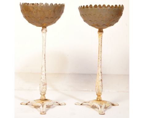 A pair of vintage mid century cast iron jardinières. The plant stands having white painted Coalbrookdale style cast metal tri