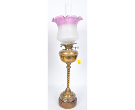 A 19th century Victorian brass oil lamp having a brass reservoir over a barley twist&nbsp; over a stepped circular base with 