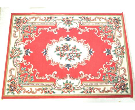 A vintage 20th century Persian Islamic carpet floor rug having a red background with a cream central medallion with flower de