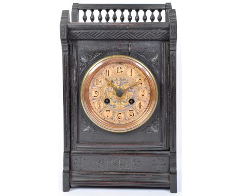 A Victorian 19th century eight day oak cased mantel clock. The clock having raised pierced gallery back, floral carved spandr