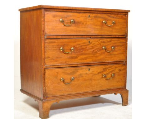 A George III early 19th century mahogany chest of drawers. The chest having a flared top over a bank of three drawers with pa