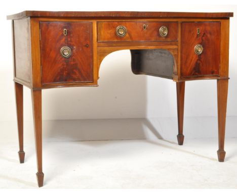 A 20th century Regency revival mahogany sideboard. The credenza having a serpentine bow front with a central burr drawer flan