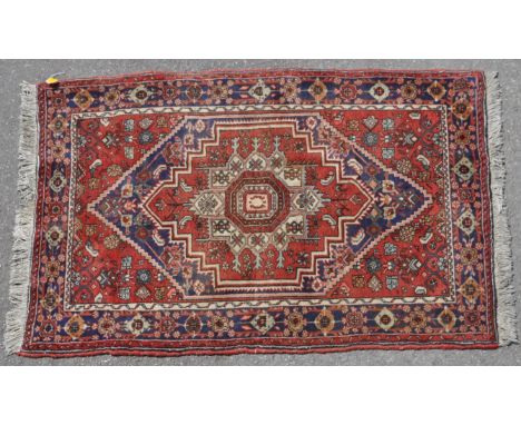 A 20th century Persian Islamic Bidjar thick pile rug carpet having a central red medallion set with a blue diamond. The outer