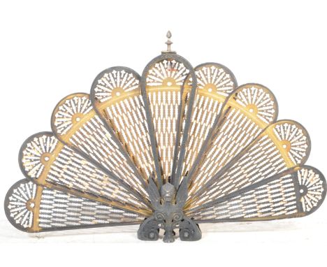 An Art Deco circa. 1920's peacock fan fireguard having pierced motifs to board and griffin modelled in relief to base. Measur
