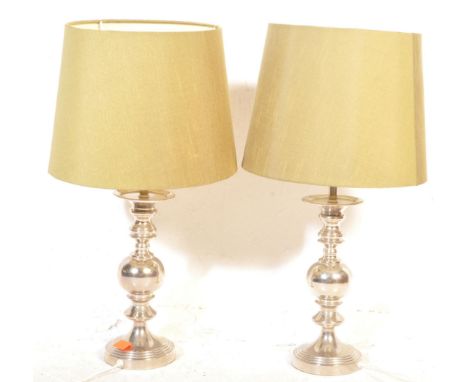 A pair of contemporary chrome finish candelabra style table lamps with matching tapering green shades. The lamps having a sph