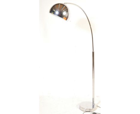 A retro vintage style chrome floor lamp in the manner of Harvey Guzzini. The lamp having an adjustable domed spherical shade 