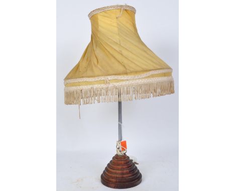 A vintage 20th century circa. 1930's mahogany base table lamp having a wooden beehive base and twisted chiffon yellow bell sh