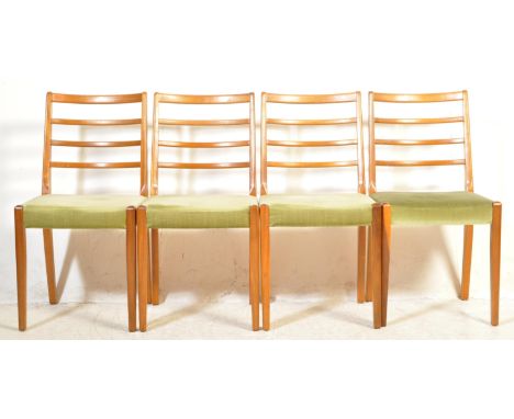 A collection of four vintage retro mid 20th century circa. 1960's teak wood dining chairs. Each having ladder backs with a se