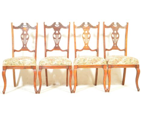 A set of four Victorian 19th century mahogany dining chairs having a scrolled crest rail, pierced lyre shaped splat, upholste