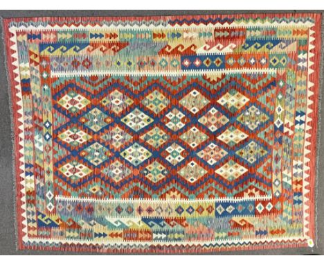 A 20th century Persian Islamic Anatolian Kilim rug carpet having a central panel decorated with a repeating diamond motif set