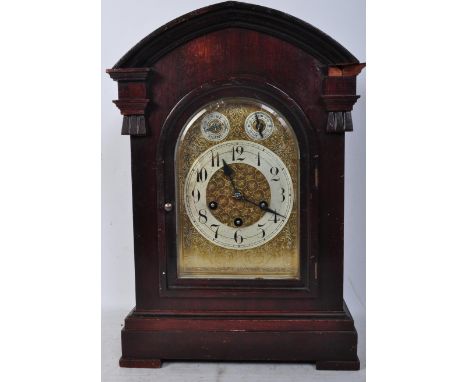 An early 20th century German Junghans large mahogany cased bracket mantel clock. The clock having a central arched glazed pan