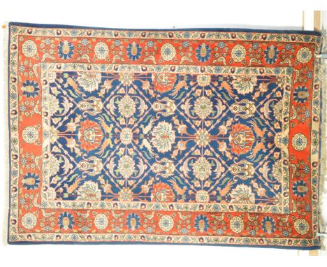 A 20th century Turkish Ushak Oushak rug carpet having a blue ground with foliate floral type motifs to centre surrounded by a