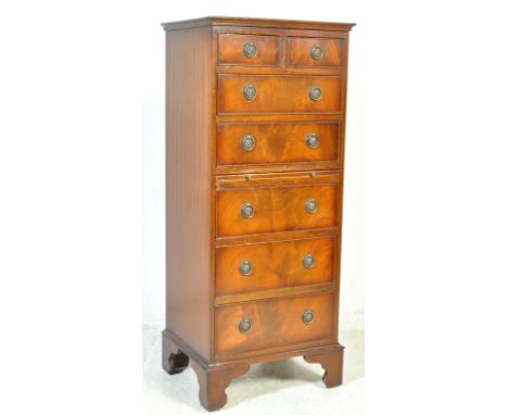 A Regency revival tall pedestal bachelors chest of drawers. Raised on bracket feet with an upright body having six drawers wi