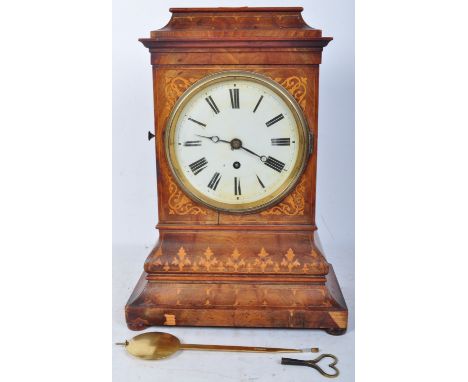 A 19th century Victorian Schollach walnut cased mantel clock having inlaid spandrels, Roman numerals to the chapter ring, rai