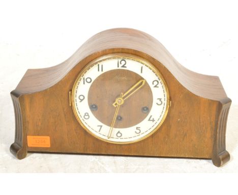 A vintage retro mid 20th century oak cased German Kienzle tambour Napoleon mantel clock. The mantle clock face having Arabic 