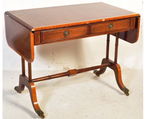 A 20th century Regency Revival drop-leaf console sofa table having crossbanding to the table top with two inlaid frieze drawe