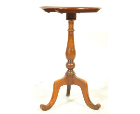 A Victorian 19th century mahogany tripod pedestal table being raised on splayed legs with turned column to centre having a ci