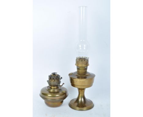 An early 20th century oil paraffin gas lamp having a brass reservoir raised on a flared base. Model Aladdin 23. Together with