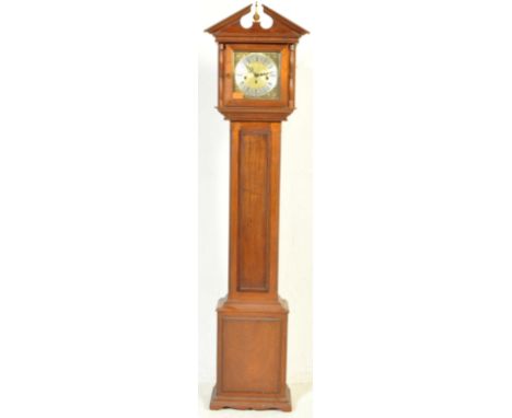 A contemporary oak cased grandmother clock having a central finial to the pediment top, floral spandrels&nbsp; to the clock f