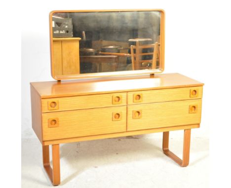 A vintage mid 20th century Schreiber teak dressing table having a central curved edge mirror of rectangular form having a ban