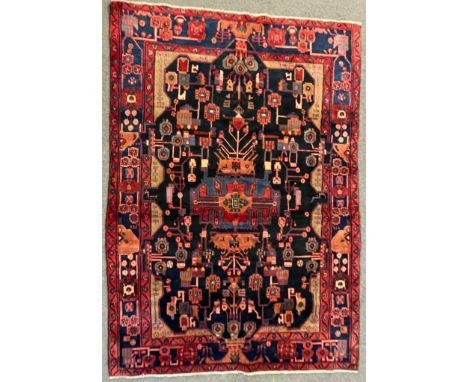 A vintage 20th century Persian Islamic Nahawand rug carpet having a central medallion with stylised foliate decoration &amp; 