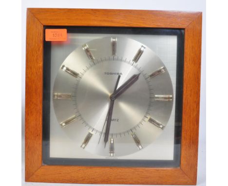 A vintage retro 20th century Toshiba Quartz wall clock having a chrome face with gilt metal to the chapter ring and being set