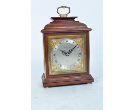 A vintage 20th century oak cased Garrard mantel clock with silvered face with roman numeral to the chapter ring. The clock fa