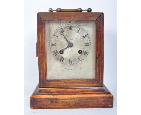 An early 20th century French Henri Marc of Paris mantel clock having inlaid floral detailing, silvered clock face with Roman 