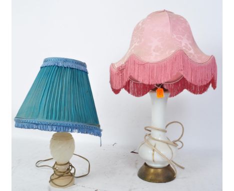 A pair of early 20th century Art Deco era table lamps to include an opaline milk glass lamp with painted gilt details, togeth